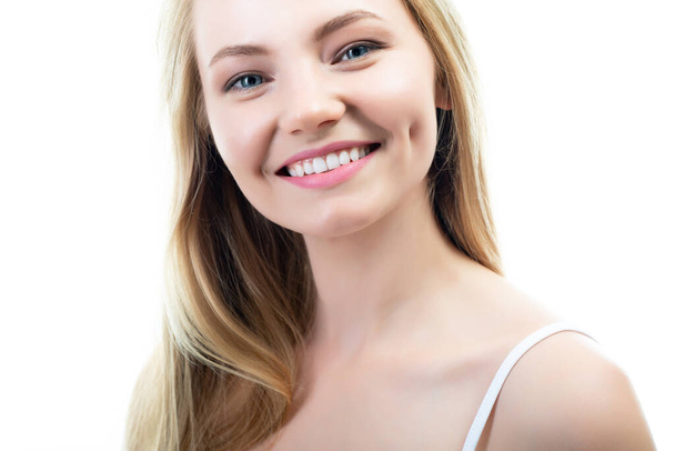 Happy young attractive blond woman with beautiful smile and healthy teeth, over white background. Dental health, whitening, prosthetics and care - Φωτογραφία, εικόνα