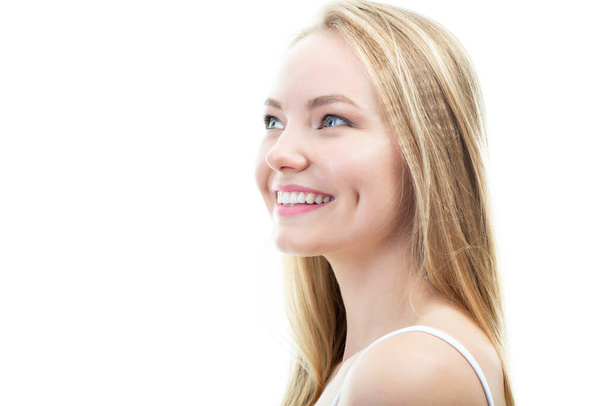 Happy young attractive blond woman with beautiful smile and healthy teeth, over white background. Dental health, whitening, prosthetics and care - Zdjęcie, obraz
