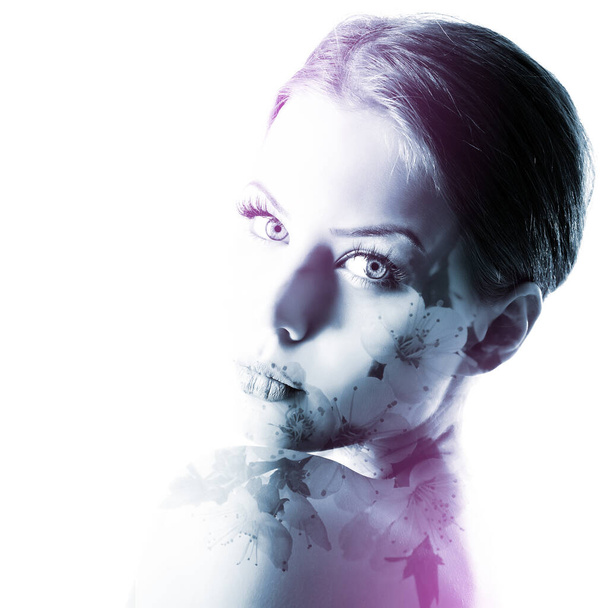 Beautiful young female face with spring blooming cherry tree flowers, double exposure. Beauty treatment, youth, springtime concept - Zdjęcie, obraz