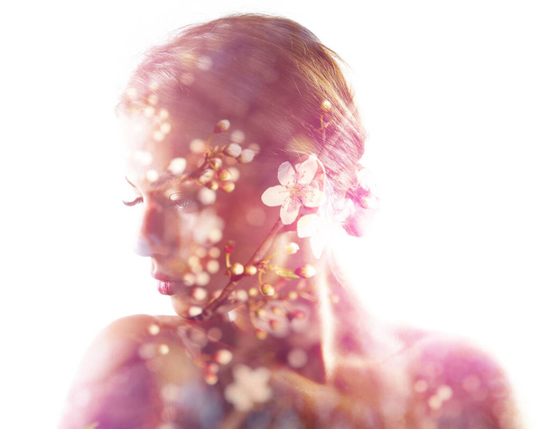 Beautiful young woman with spring blooming cherry tree flowers, double exposure. Beauty treatment, youth, springtime concept - Fotó, kép
