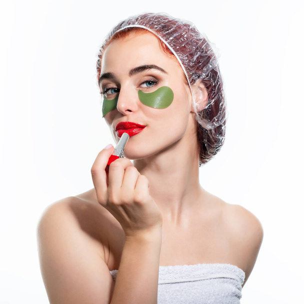Young woman makes make-up with patches and red lipstick at the morning  - Foto, Imagen