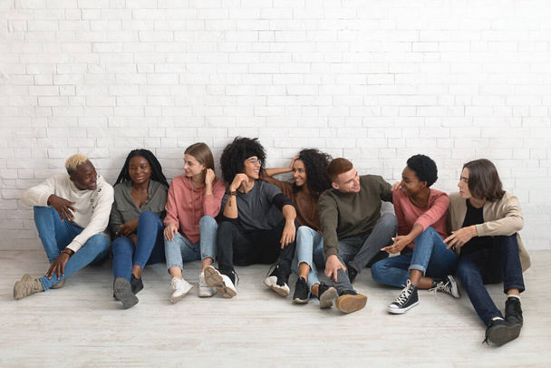 Multiracial millennials chilling together, sitting on floor - Foto, Imagem