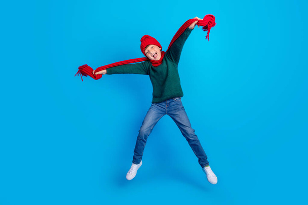 Full length body size photo boy jumping cheerful wearing winter clothes isolated bright blue color background - Fotoğraf, Görsel