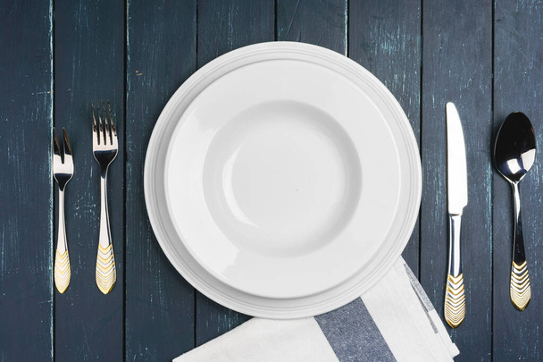 Table setup with plates on dark wooden background - Zdjęcie, obraz
