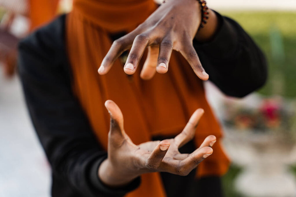 Close-up handen van zwarte moslim vrouw bij Qigong Chinese meditatie en sport training outdoor. Afrikaans meisje is mediteren outdoor in de buurt van Chinese prieel - Foto, afbeelding