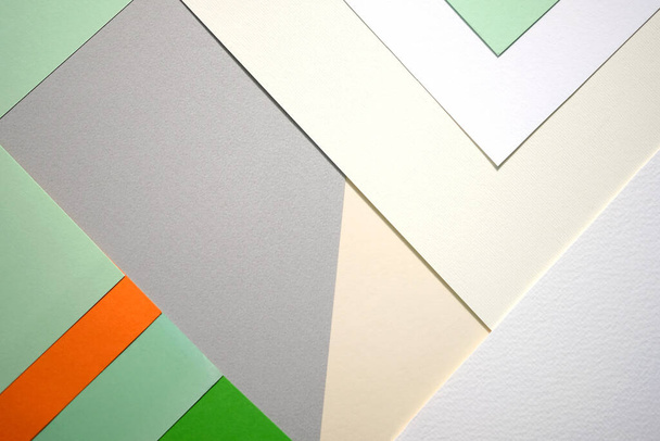 Colored paper sheets abstraction. Background from paper laid out in the form of geometric shapes. Abstraction from paper of different colors top view.  - Фото, зображення