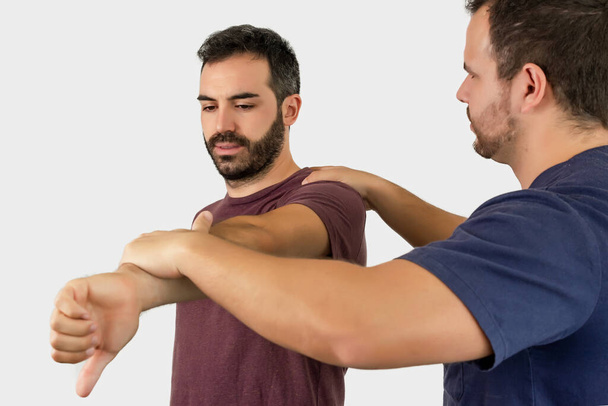 Physiotherapist performing arm exercises with the patient - Foto, immagini