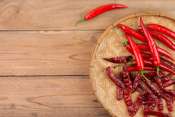 Fresh chili and dried chili, placed on the wooden floor, top view with copy space. - Foto, Bild