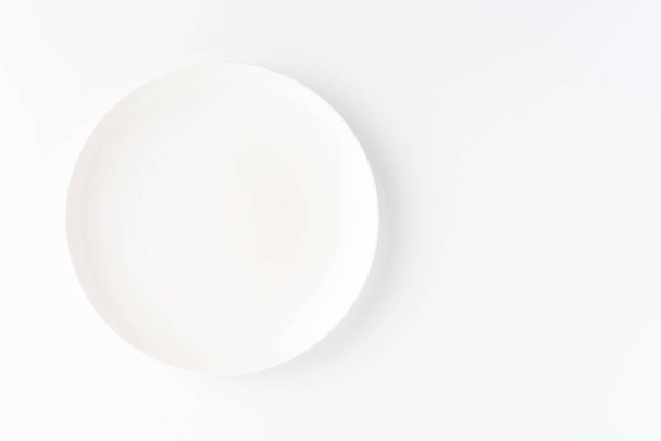 Empty white plate isolated on white background. Top view - Valokuva, kuva