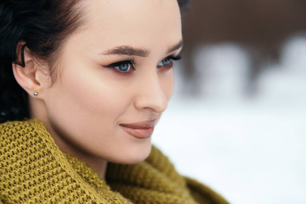 Pretty woman smile stand outside street snow old park forest weather winter holiday New Year Christmas dressed knitted warm sweater and scarf, blue eyes copy space blurred bokeh background. - Foto, Imagem
