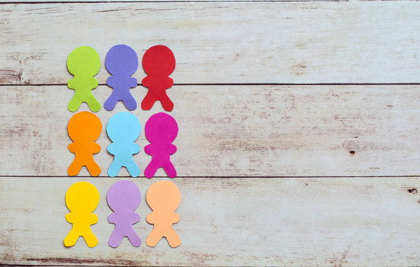 Paper cut colorful people, inclusion and diversity concept on a wooden background  - Foto, Imagem