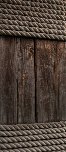Hemp rope on weathered wood background - Photo, Image
