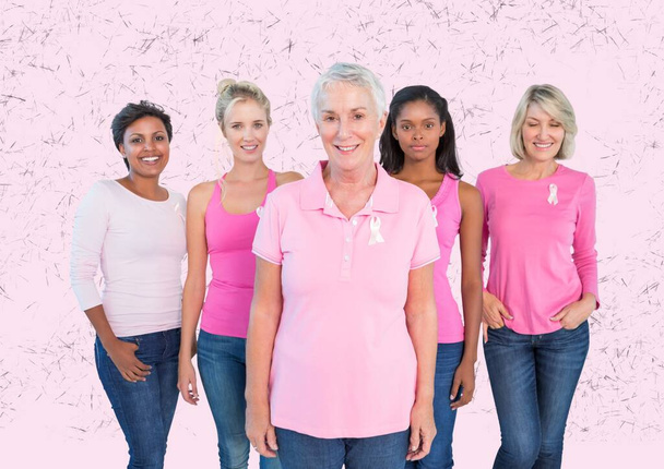 Group of women smiling wearing a pink ribbons on their sleeves against textured pink background. breast cancer awareness concept - Foto, Imagem