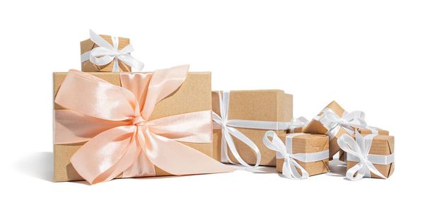 A lot of gifts tied with a white ribbon on a white isolated background. Celebration and congratulations holiday concept - Foto, immagini