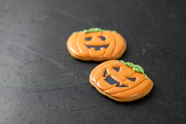Bright happy Halloween gingerbread cookies on a black background - Фото, изображение