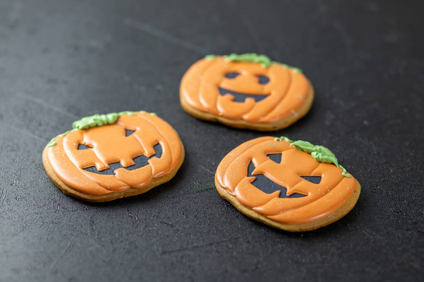 Bright happy Halloween gingerbread cookies on a black background - Foto, immagini