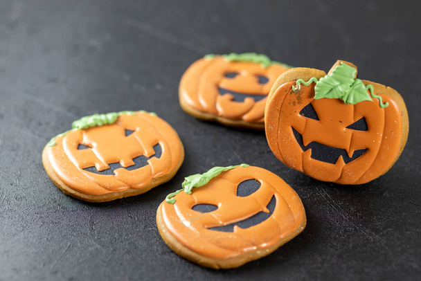 Bright happy Halloween gingerbread cookies on a black background - Foto, immagini