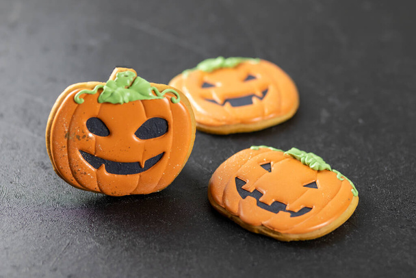 Bright happy Halloween gingerbread cookies on a black background - Photo, Image