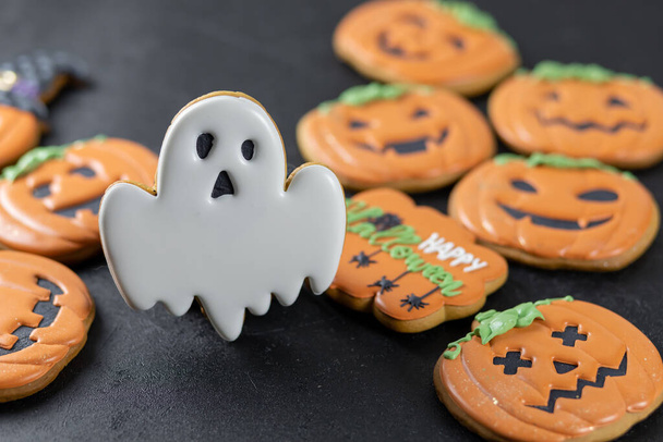 Bright Halloween gingerbread cookies on a black background - Фото, изображение