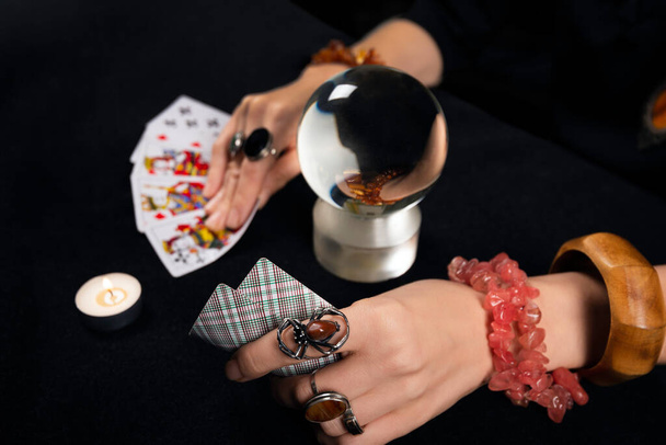 Fortune teller or witch hands, cards, candles and magic ball. Halloween, magic and tricks concept. ten spades card - Фото, зображення