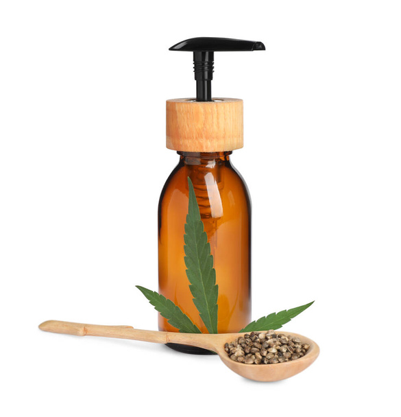 Bottle of hemp cosmetics with green leaf and seeds isolated on white - Foto, Bild