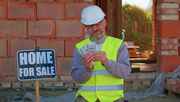 Happy rich real-estate agent architect selling new house, service man in uniform with cash income - Photo, Image