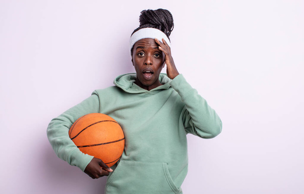 pretty black woman looking happy, astonished and surprised. basketball concept - Fotografie, Obrázek