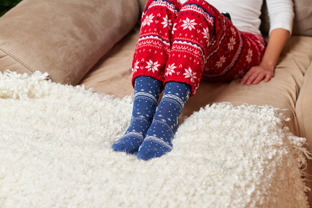 Person wearing Christmas socks and pajamas - Фото, зображення