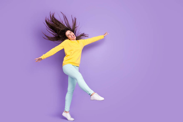 Full length photo of cheerful young happy woman raise hands walk wind blow hair isolated on purple color background - Valokuva, kuva