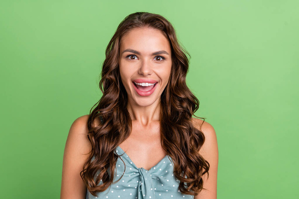 Photo of young girl happy positive smile amazed excited shocked happy positive smile news sale isolated over green color background - Foto, imagen