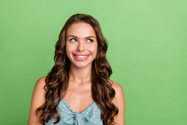 Photo of young attractive girl happy positive smile curious dream look empty space isolated over green color background - Φωτογραφία, εικόνα