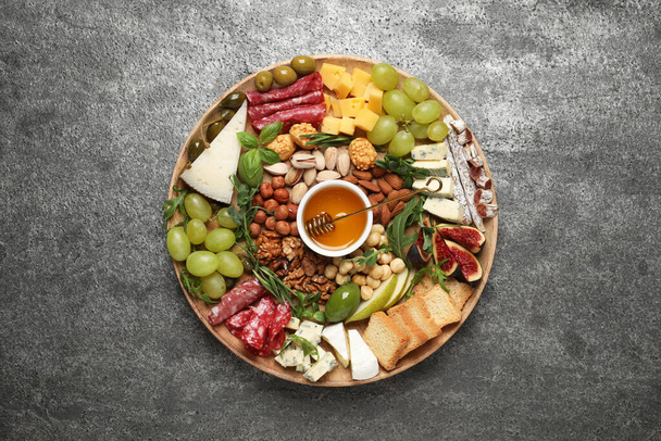 Different tasty appetizers on dark grey table, top view - Photo, image