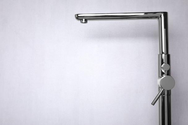 Modern single handle bathtub faucet on light grey background. Space for text - 写真・画像