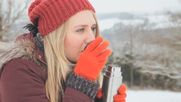 young girl with hot drink thermal flask - Materiał filmowy, wideo