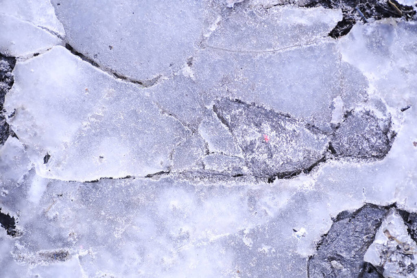 Crashed blue ice concrete surface background texture. Crashed ice concrete surface background texture. Frozen ice surface of a lake in sunset - Zdjęcie, obraz