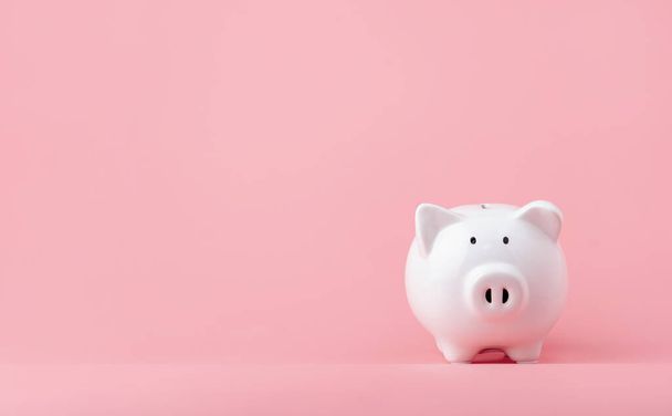 Money saving and investment concept. Piggy bank on pink background with copy space - Zdjęcie, obraz