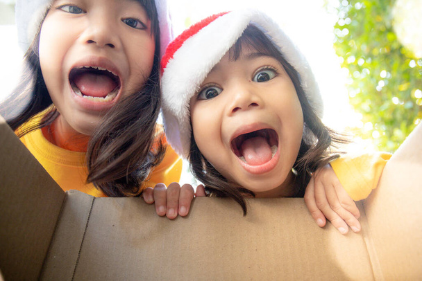Surprised children unpack Christmas gift box - Photo, Image