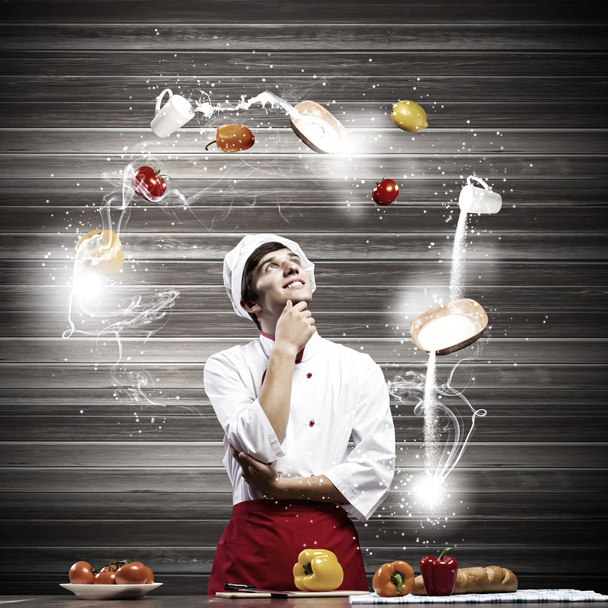Cook and ingredients flying in air - Фото, изображение