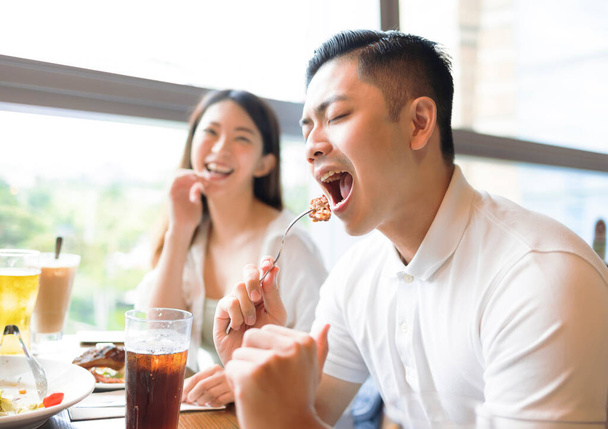 Happy couple having fun during lunch in restaurant - Фото, зображення