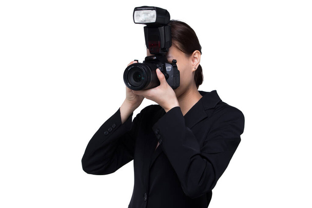 Asian Woman Photographer hold camera with external flash point to shoot subject, wear normal suit jacket. studio lighting white background isolated copy space, reporter journalist take photo celebrity - Photo, Image