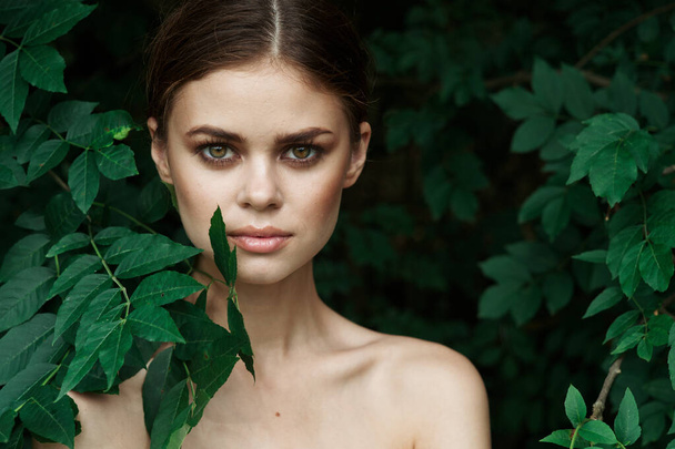 attractive woman skin care bare shoulders green leaves nature model - Foto, Imagen