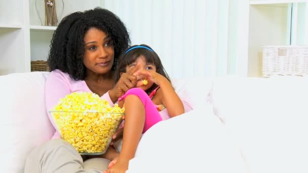 mother with her daughter eating popcorn - Footage, Video