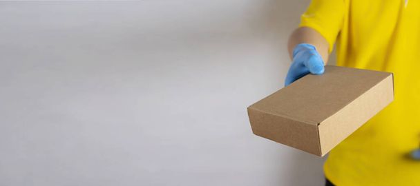 Delivery man holding cardboard boxes / copy space - Фото, изображение