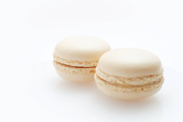 A closeup shot of delicious fresh white macaroons on a white background - Fotó, kép