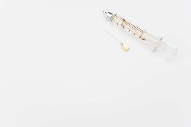 an isolated injection syringe on white paper background with text space - Foto, Bild