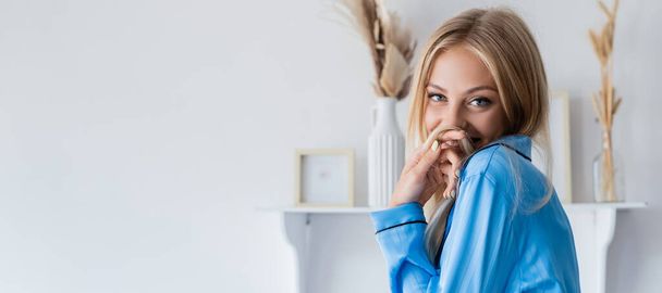 happy young woman smiling and covering mouth with hair, banner - Fotografie, Obrázek