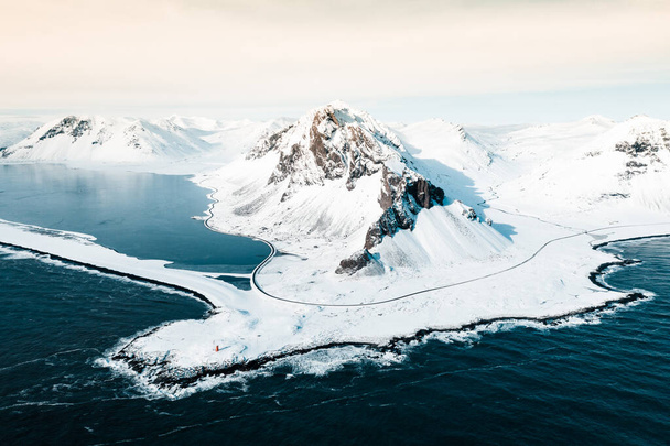Eystrahorn mountain in the Eastfjords of Iceland,covered by snow near the beach and sea in the winter, photo from drone - Photo, Image