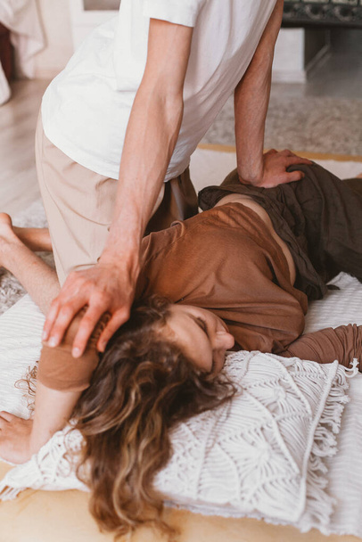 A vertical shot of a male chiropractor working with a female patient - Valokuva, kuva