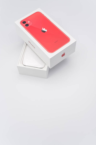 COMO, ITALY - Oct 17, 2021: iPhone 11 product red Apple smartphone box on a white tabletop with copy space - Photo, Image