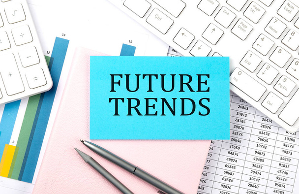 FUTURE TRENDS text on blue sticker on the chart with calculator and keyboard - Photo, Image